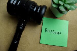 Concept of Revision write on sticky notes isolated on Wooden Table. photo
