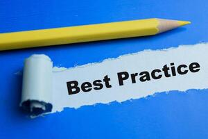 Concept of Best Practice Text written in torn paper. photo