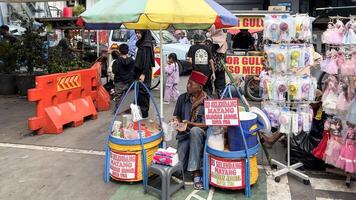 Tourists and local are eating out in the stall in the street of Jakarta in old city historic district. The city is famous for its authentic Asian food. Bekasi, Indonesia, May 1, 2024 photo