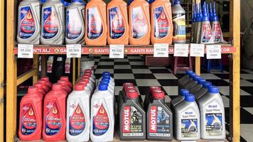 Assorted motor and engine oil bottles at a mechanic shop. Bekasi, Indonesia, April 22, 2024 photo