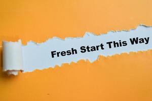 Concept of Fresh Start This Way Text written in torn paper. photo