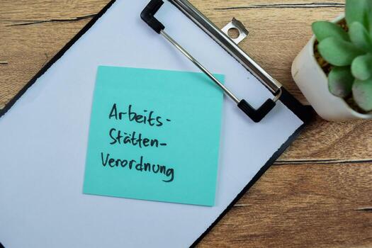 Concept of Arbeits Statten Verordnung in Language Germany write on sticky notes isolated on Wooden Table. photo