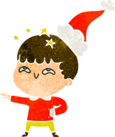 main tiré rétro dessin animé de une étonné garçon portant Père Noël chapeau png
