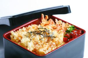 Ebi tempura don or Ebi Kakiage served with red pickled vegetables or Fukujin Zuke in white background photo