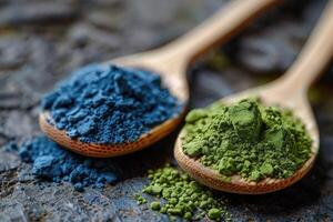 wooden spoons with green and blue matcha powder. Superfood, vegan drink photo