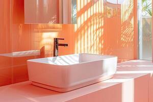 Interior of a modern bathroom with sleek white sanitary ware tiled in peach tones. Daylight, shadows from house plants from a window on a smooth wall photo