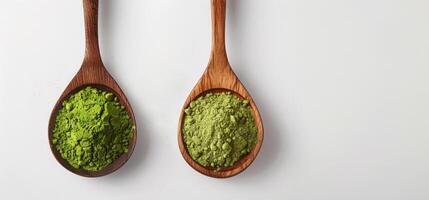 Two wooden spoons with ground green tea powder, green matcha powder, antioxidant on a white background, top view photo