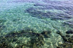 The color of water in the Mediterranean Sea in shallow water. Natural abstract background. photo