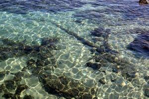 The color of water in the Mediterranean Sea in shallow water. Natural abstract background. photo