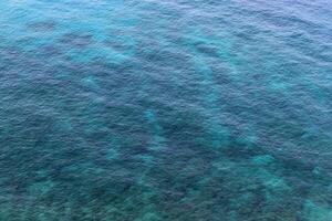 The color of water in the Mediterranean Sea in shallow water. Natural abstract background. photo