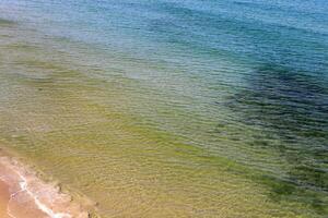 The color of water in the Mediterranean Sea in shallow water. Natural abstract background. photo