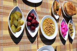 Table in a restaurant with a variety of snacks and food. photo