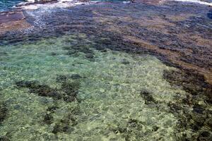 The color of water in the Mediterranean Sea in shallow water. Natural abstract background. photo