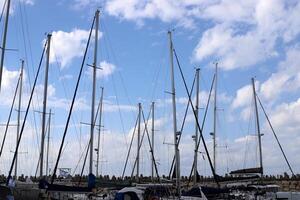 Masts in the port against the blue sky. photo