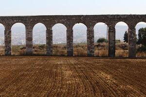 An ancient aqueduct for supplying water to populated areas. photo