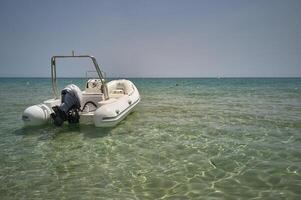 The motorboat on the shore of the sea. photo