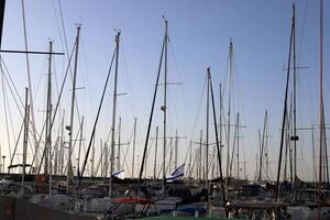 Masts in the port against the blue sky. photo