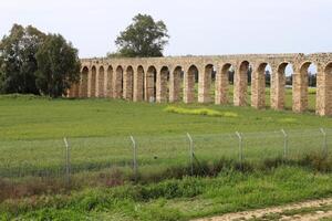 An ancient aqueduct for supplying water to populated areas. photo