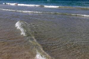 The color of water in the Mediterranean Sea in shallow water. Natural abstract background. photo