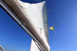 Masts in the port against the blue sky. photo