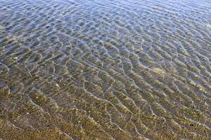 The color of water in the Mediterranean Sea in shallow water. Natural abstract background. photo