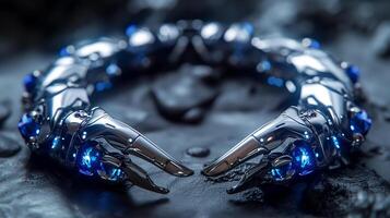 An edgy, futuristic scorpion-shaped bracelet featuring neon blue sapphires and polished silver. photo