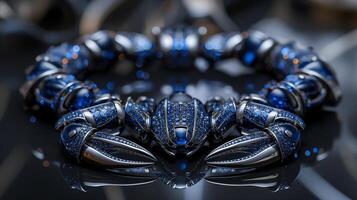 An edgy, futuristic scorpion-shaped bracelet featuring neon blue sapphires and polished silver. photo