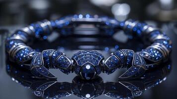 An edgy, futuristic scorpion-shaped bracelet featuring neon blue sapphires and polished silver. photo