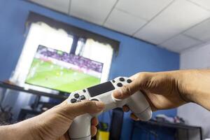 Hands holding a joystick play a game photo