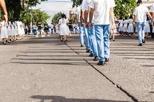 military parade of high school students in a street. patriotic parade concept. photo