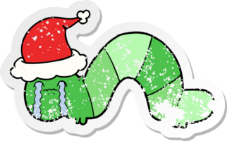 hand drawn distressed sticker cartoon of a caterpillar obsessing over his regrets wearing santa hat png