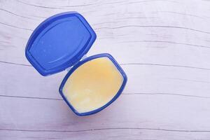 white petroleum jelly in a container, Top view photo