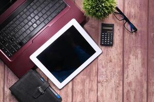 Flat composition of digital tablet and office stationary on black background photo