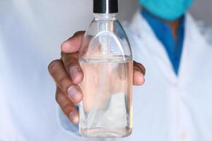 Doctor hand holding hand sanitizer for preventing virus photo