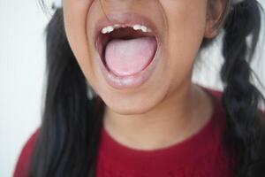 close up of child screaming at home photo