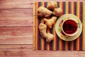 Ginger tea with ginger on table , high angle view . photo