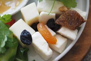 Cheese platter with dry food on a plate photo