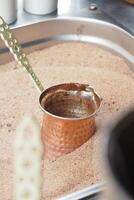 top view of making traditional turkish coffee on sand photo