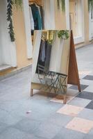 A mirror sits on a tiled floor outside a building photo