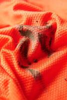 orange color cloth stain closeup photo