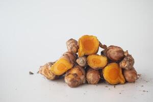 detail shot of turmeric root in bowl on table , photo