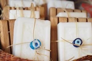 Stack of soap topped with evil eye beads, photo