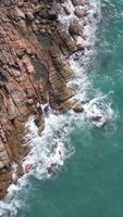 Aerial View Of Calm Turquoise Waves On Rocky Tropical Coastline video