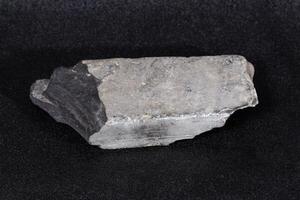 the bottom of gray flat brick shaped rock found many years ago photo