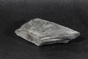 right side of gray flat brick shaped rock found many years ago photo