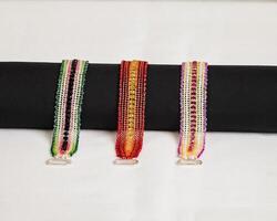 a group of three hand stitched flat beaded bracelets photo