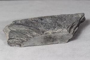 a gray flat brick shaped rock found many years ago photo