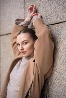 Young beautiful woman wearing coat walking in the city centre of Prague, Czech republic, Europe photo