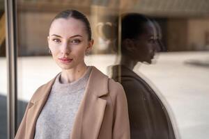 Portrait of young beautiful woman wearing coat walking in the city centre of Prague, Europe. High quality photo