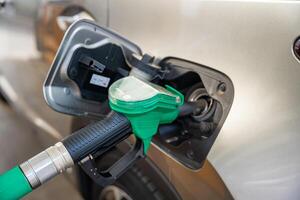 A car being refueled at petrol or gas self-service filling station in Europe photo